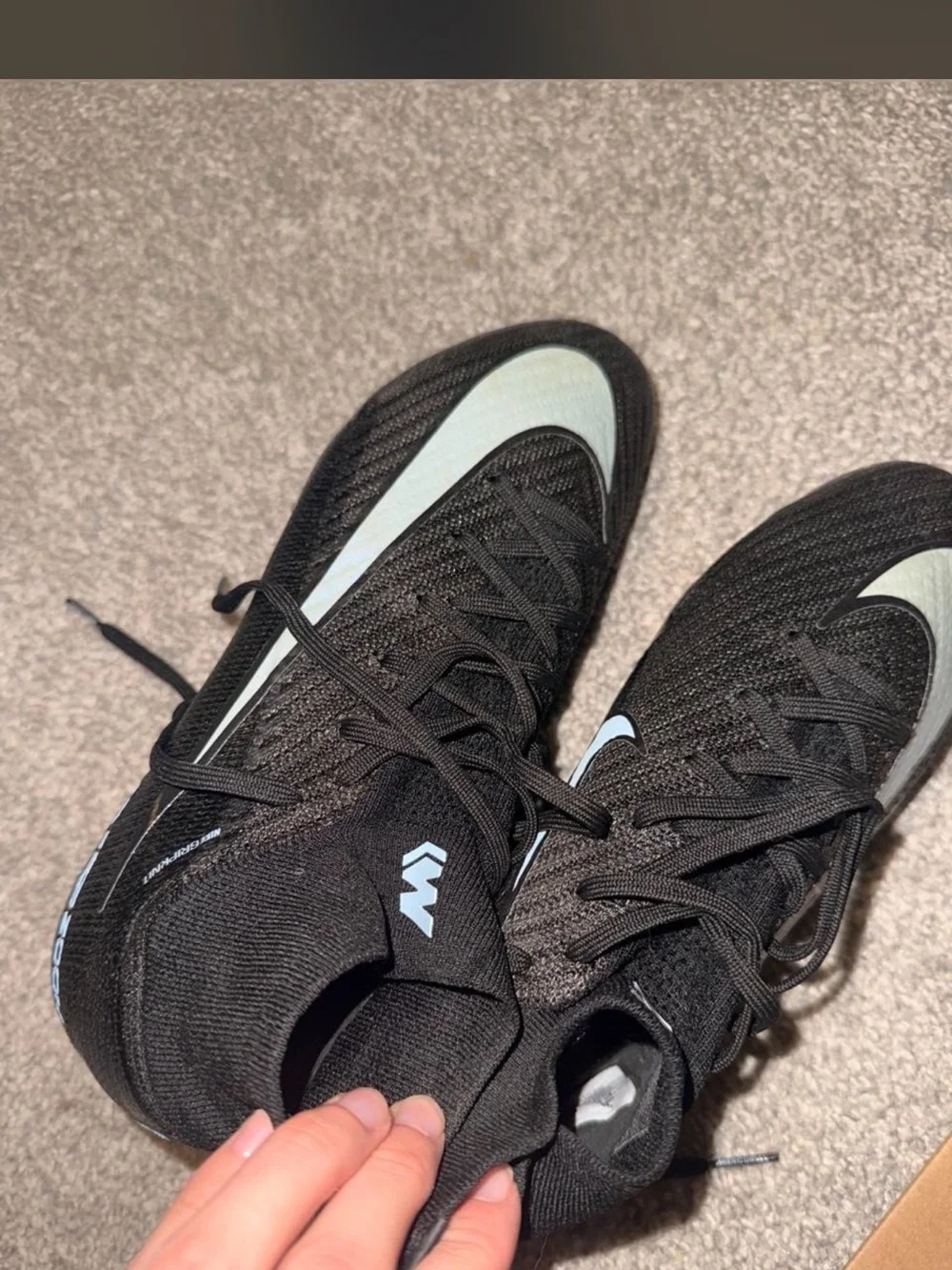 Nike woman’s Gen 4 black and light blue soccer cleats size 6
